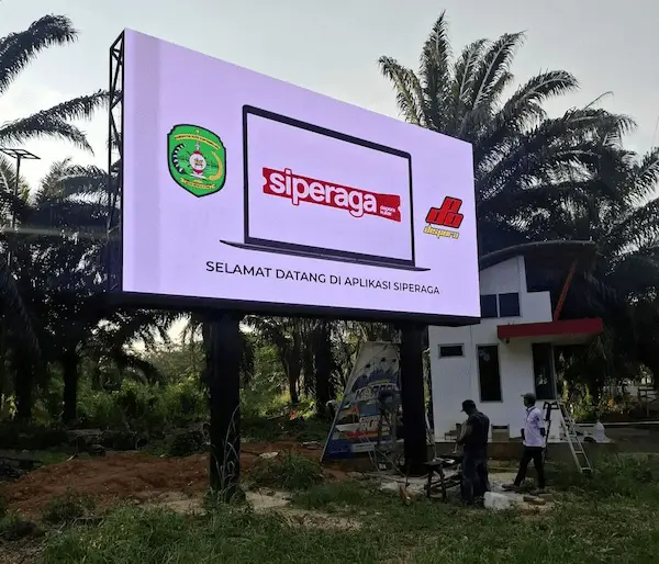 hasil konstruksi videotron outdoor billboard dengan tampilan LED display menyala di area publik